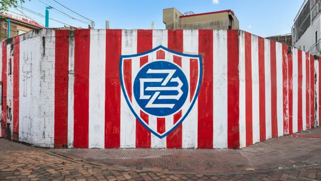 Crest on a striped wall