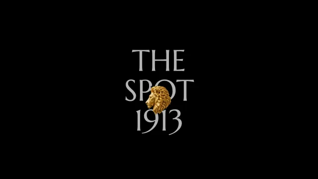 The Spot 1913 wordmark with a gold statue